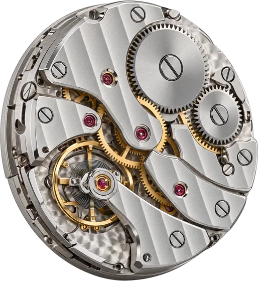 A hand-assembled mechanical watch movement, seen from the back, its gears and jewels visible.